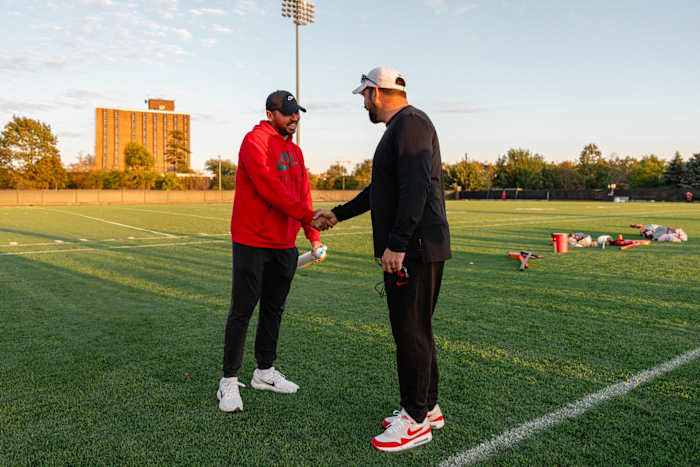 PGA Tour golfer Jason Day (left) shakes hands with Ohio State coach Ryan Day (right) at the Buckeyes' practice on Tuesday.